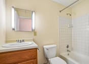 Thumbnail 38 of 44 - A bathroom with a toilet, sink, and bathtub.