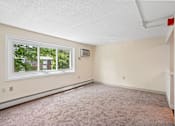 Thumbnail 22 of 44 - A room with a window and a carpeted floor.
