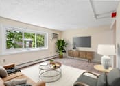 Thumbnail 41 of 44 - A living room with a couch, chair, and television.