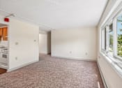 Thumbnail 23 of 44 - A large empty room with a window on the right side.