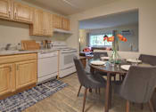 Thumbnail 7 of 19 - A kitchen with a table and chairs set for two.