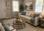 Thumbnail 22 of 26 - A living room with a couch, chair, and table.