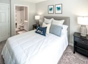 Thumbnail 7 of 35 - A bedroom with a large bed and two lamps.