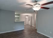 Thumbnail 21 of 35 - A room with a ceiling fan and light fixture.