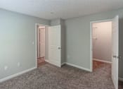 Thumbnail 18 of 35 - A room with two doors, one of which is open.