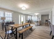 Thumbnail 5 of 24 - A dining room with a wooden table and chairs.