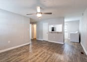 Thumbnail 20 of 24 - A spacious room with a ceiling fan and light fixture.