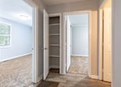 Thumbnail 17 of 24 - A white closet with a door open to a room.
