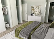 Thumbnail 16 of 24 - A bedroom with a bed covered in a green and grey blanket.