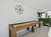 Thumbnail 21 of 42 - A long wooden table with a compass on the wall.