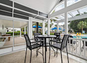 Thumbnail 22 of 42 - A table with four chairs is on a patio.