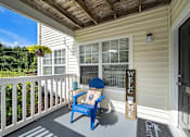 Thumbnail 41 of 42 - A blue chair sits on a porch with a sign that says "Welcome".