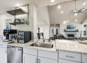 Thumbnail 15 of 42 - A modern kitchen with granite countertops and stainless steel appliances.