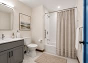 Thumbnail 6 of 7 - A bathroom with a toilet, sink, and shower.