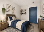 Thumbnail 3 of 7 - A bedroom with a bed, nightstand, and a blue door.