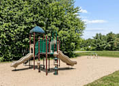 Thumbnail 12 of 19 - A playground with a green slide and a brown slide.