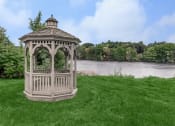 Thumbnail 11 of 57 - a gazebo sitting on the grass near a river