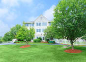 Thumbnail 13 of 57 - a large white house with a lawn and trees in front of it