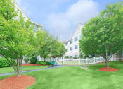 Thumbnail 14 of 57 - a yard with grass and trees and a white fence