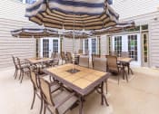 Thumbnail 16 of 57 - a patio with tables and chairs and umbrellas