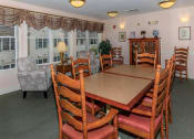 Thumbnail 21 of 57 - a dining room with a wooden table and chairs