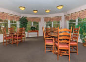Thumbnail 22 of 57 - a dining room with a table and chairs