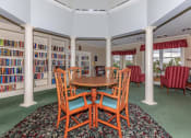 Thumbnail 23 of 57 - a dining room with a table and chairs in a library