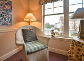 Thumbnail 32 of 57 - a chair with a pillow sitting in front of a window