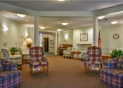 Thumbnail 39 of 57 - a lobby with chairs and tables and a piano