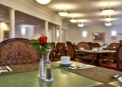 Thumbnail 41 of 57 - a dining room with tables and chairs and a flower in a vase