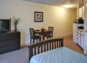 Thumbnail 44 of 57 - a hotel room with a bed and a table and a television