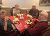 Thumbnail 51 of 57 - a group of people sitting around a table eating food
