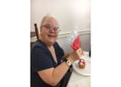 Thumbnail 52 of 57 - a woman sitting at a table with a cupcake