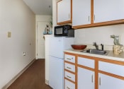 Thumbnail 54 of 57 - a kitchen with a sink a refrigerator and a microwave