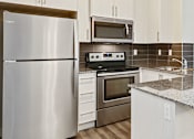 Thumbnail 8 of 44 - a kitchen with stainless steel appliances and white cabinets