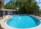 Thumbnail 1 of 11 - A small pool with a white border and a black fence.