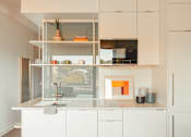 Thumbnail 3 of 36 - a white kitchen with white cabinets and a window at Scout Living, powered by Placemakr Apartments, Georgia