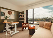 Thumbnail 1 of 36 - a living room with a couch and a desk at Scout Living, powered by Placemakr Apartments, Atlanta, Georgia