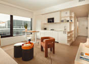Thumbnail 9 of 36 - a living room with a kitchen and a large window at Scout Living, powered by Placemakr Apartments, Atlanta, GA, 30308