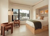 Thumbnail 22 of 36 - a hotel room with a bed and a window at Scout Living, powered by Placemakr Apartments, Atlanta, GA