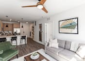 Thumbnail 20 of 23 - A living room with a green couch and a ceiling fan at Anthem House Apartment , Huntsville, 35806