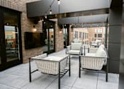 Thumbnail 7 of 53 - Two wicker chairs with cushions are placed on a patio at Anthem House, Huntsville, 35806
