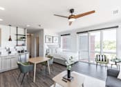 Thumbnail 12 of 23 - A modern living room with a dining table and chairs at Anthem House Apartment , Alabama, 35806