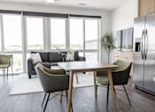 Thumbnail 7 of 23 - A modern kitchen with a dining table and chairs at Anthem House Apartment , Huntsville, AL