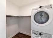 Thumbnail 14 of 23 - A white washing machine in a small laundry room at Anthem House Apartment , Huntsville, AL