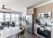Thumbnail 4 of 23 - A modern kitchen with a dining table and chairs at Anthem House Apartment , Huntsville, Alabama