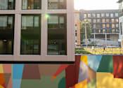 Thumbnail 27 of 36 - a view of a building with rainbow flags in front of it at Scout Living, powered by Placemakr Apartments, Atlanta, GA