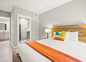 Thumbnail 23 of 28 - A bedroom with a large bed and a wooden headboard at Coda on Half Apartments, Washington, DC