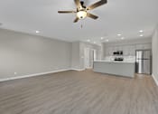 Thumbnail 4 of 36 - an empty living room and kitchen with a ceiling fan