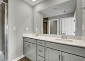 Thumbnail 12 of 36 - a bathroom with two sinks and a shower and a mirror